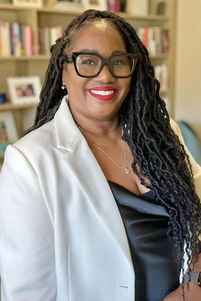 Dr. Kimberly VanBuren, expert online life coach, smiling in a professional setting